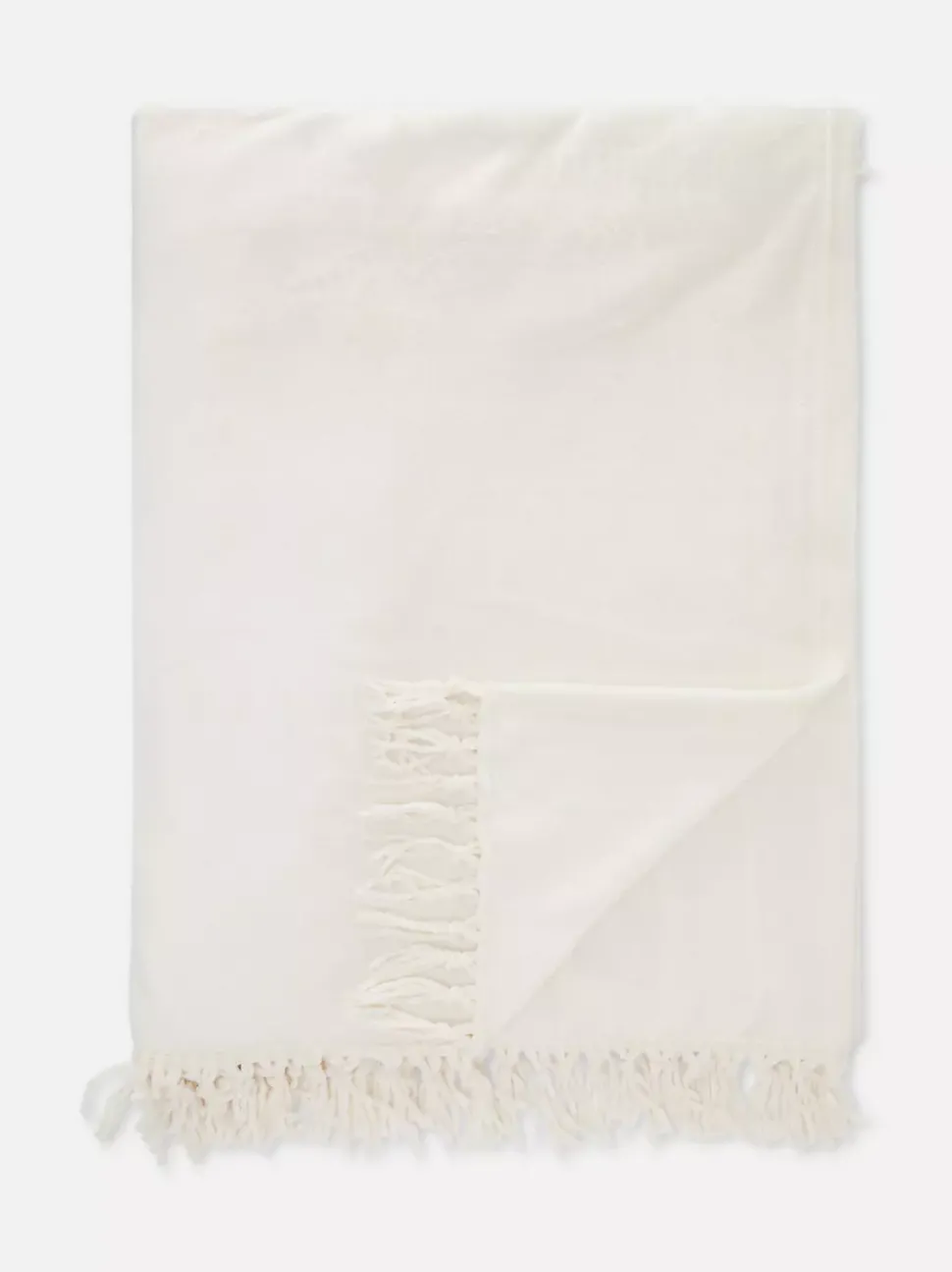 Duża miękka narzuta z frędzlami przy obszyciu