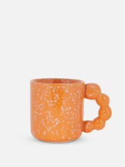 Nakrapiany kubek z uchem w kształcie bąbelków