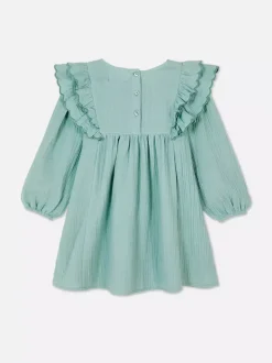 Sukienka z falbaną w kwiaty z muszelkowym brzegiem