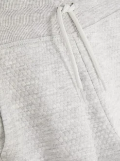 Teksturowane spodnie dresowe ściągane sznurkiem