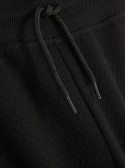 Teksturowane spodnie dresowe ściągane sznurkiem